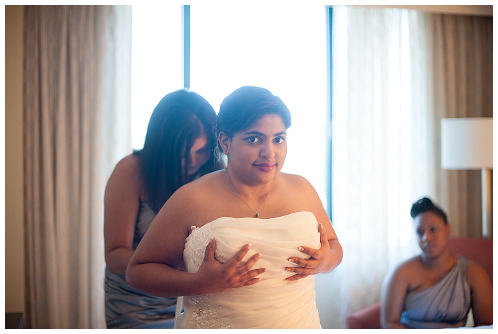 bride getting into dress backlight