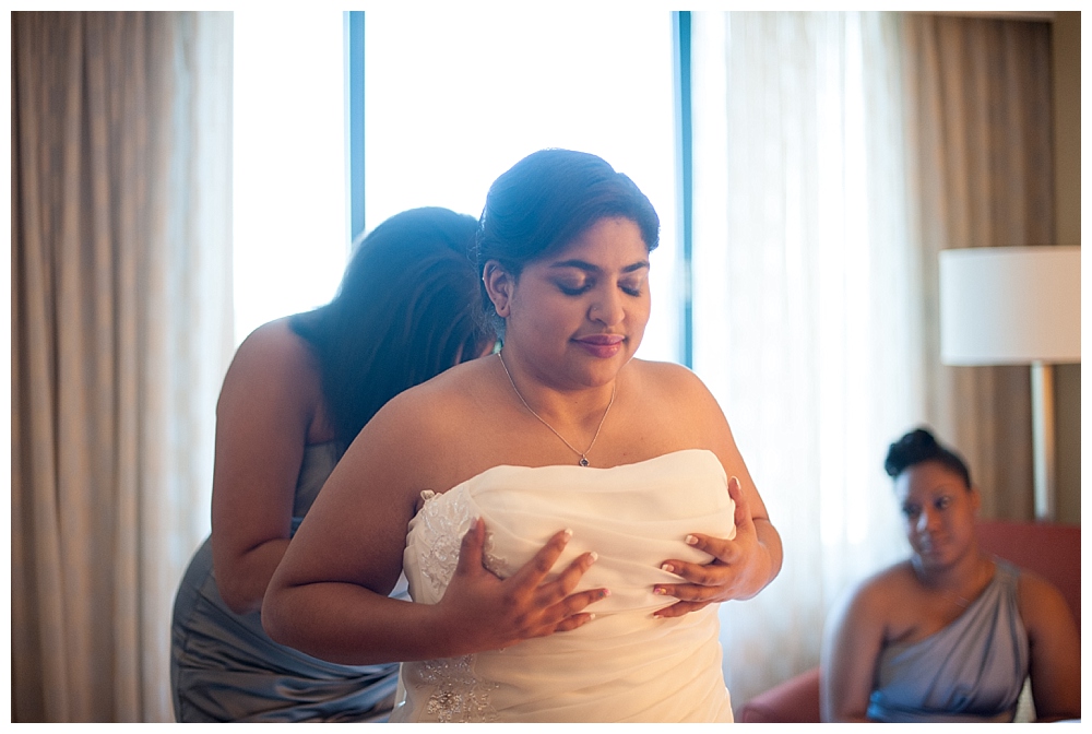 bride getting into dress backlight