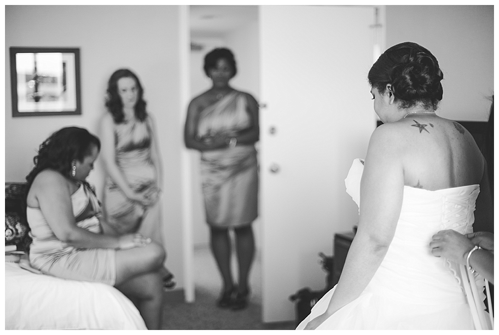 bride getting into dress backlight