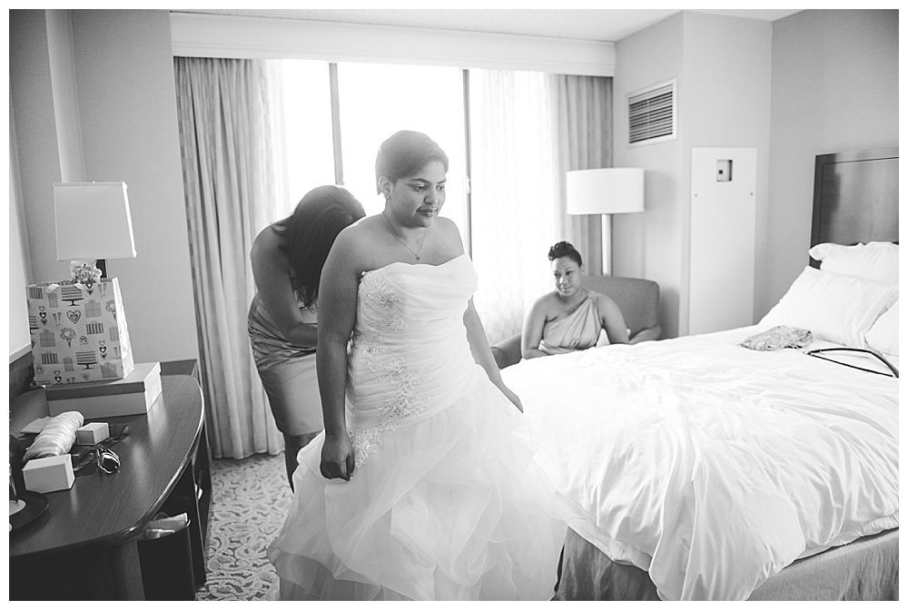 bride getting into dress backlight