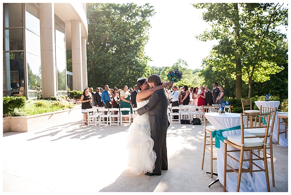 bride groom kiss while guests watch