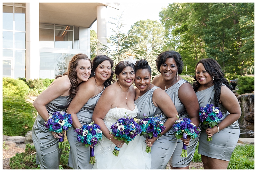 bridal party gray dresses blue and purple bouquets