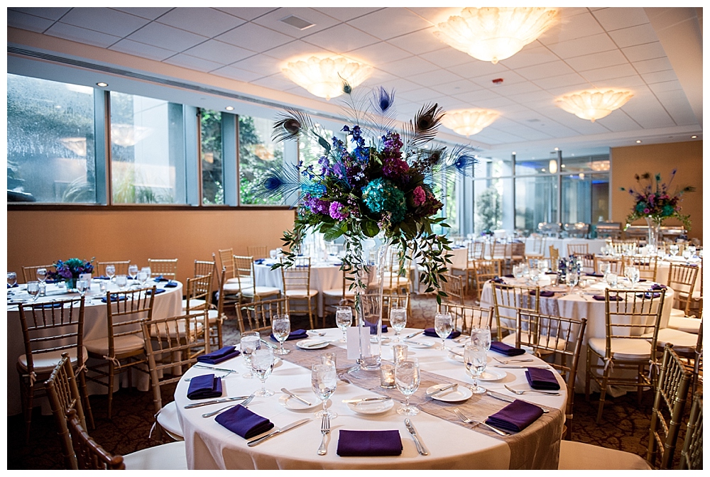 wedding reception tables with blue and purple centerpieces