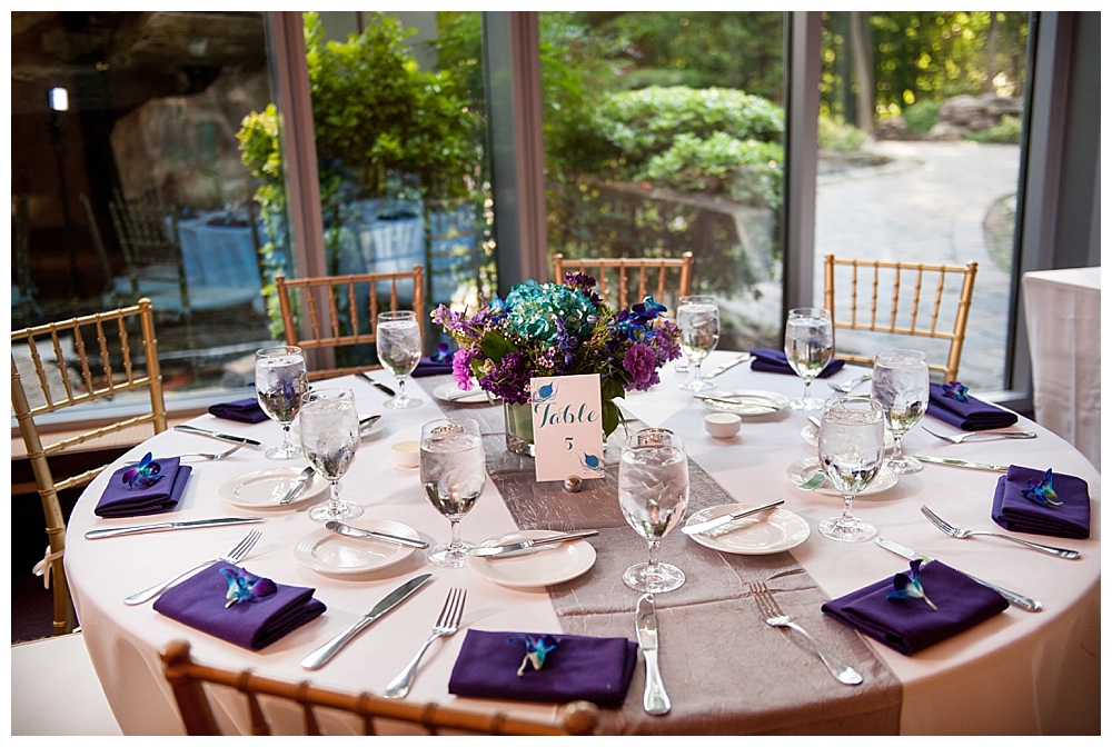 wedding reception tables with blue and purple centerpieces