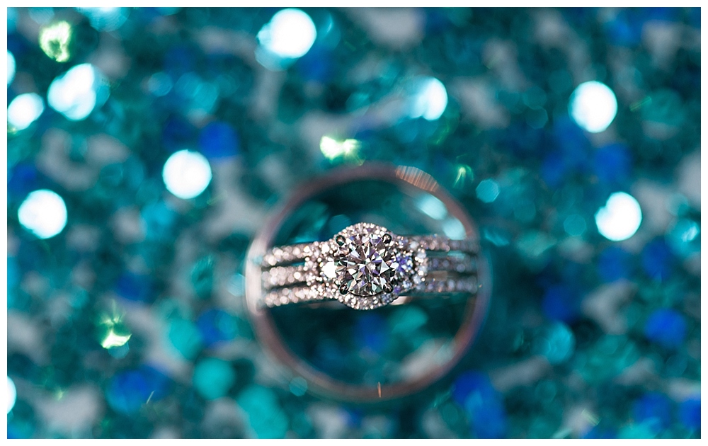 wedding rings on blue sparkly background