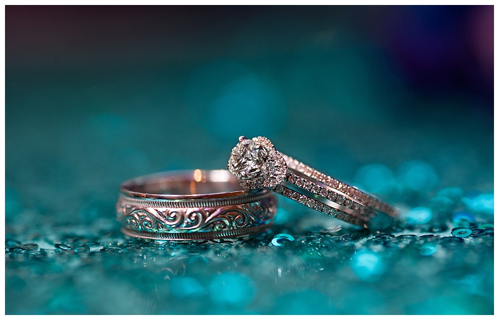 wedding rings on blue sparkly background
