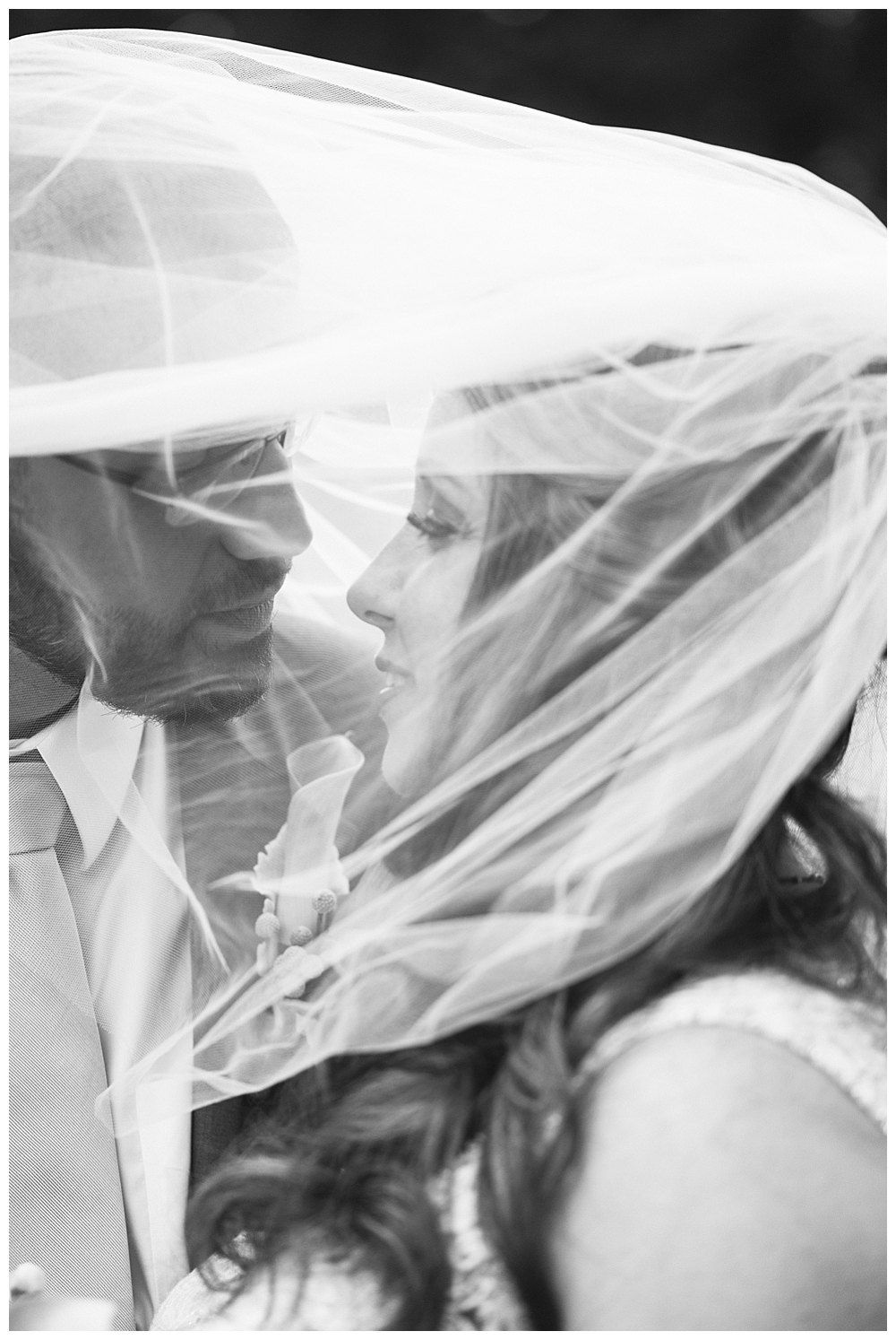 bride and groom under veil black and white
