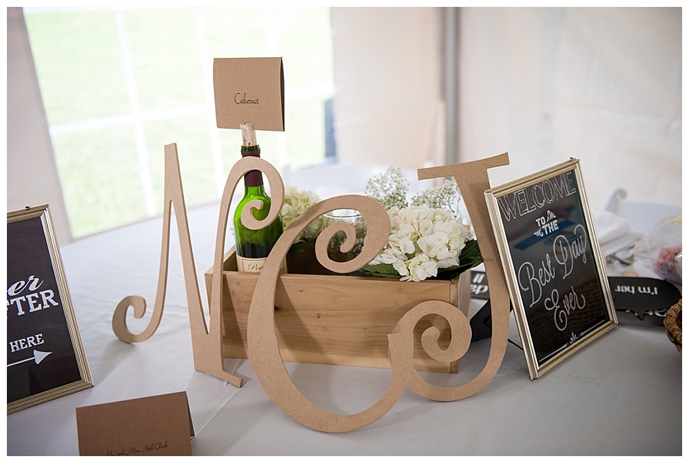 table at reception with wine bottles and bo