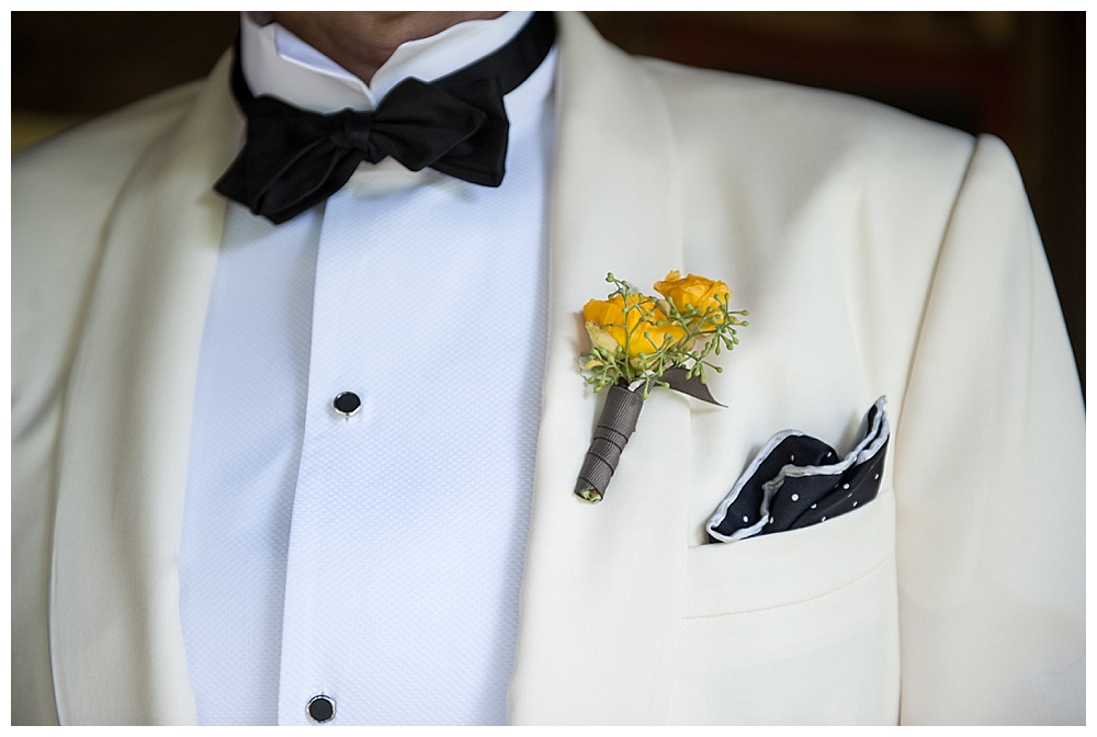 Groom with yellow boutinere and black bow tie