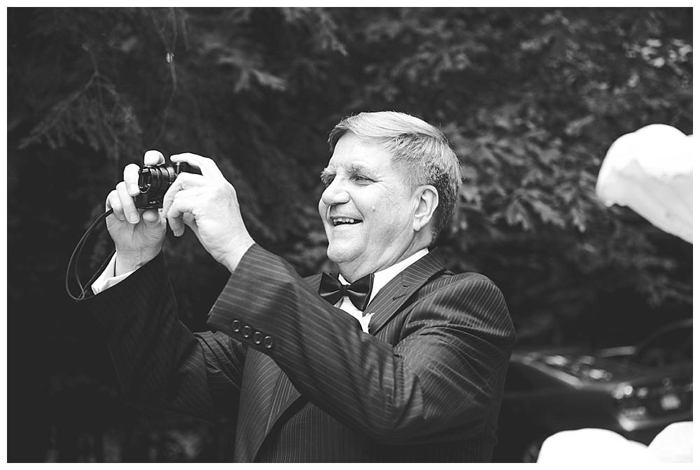 father of bride taking photos