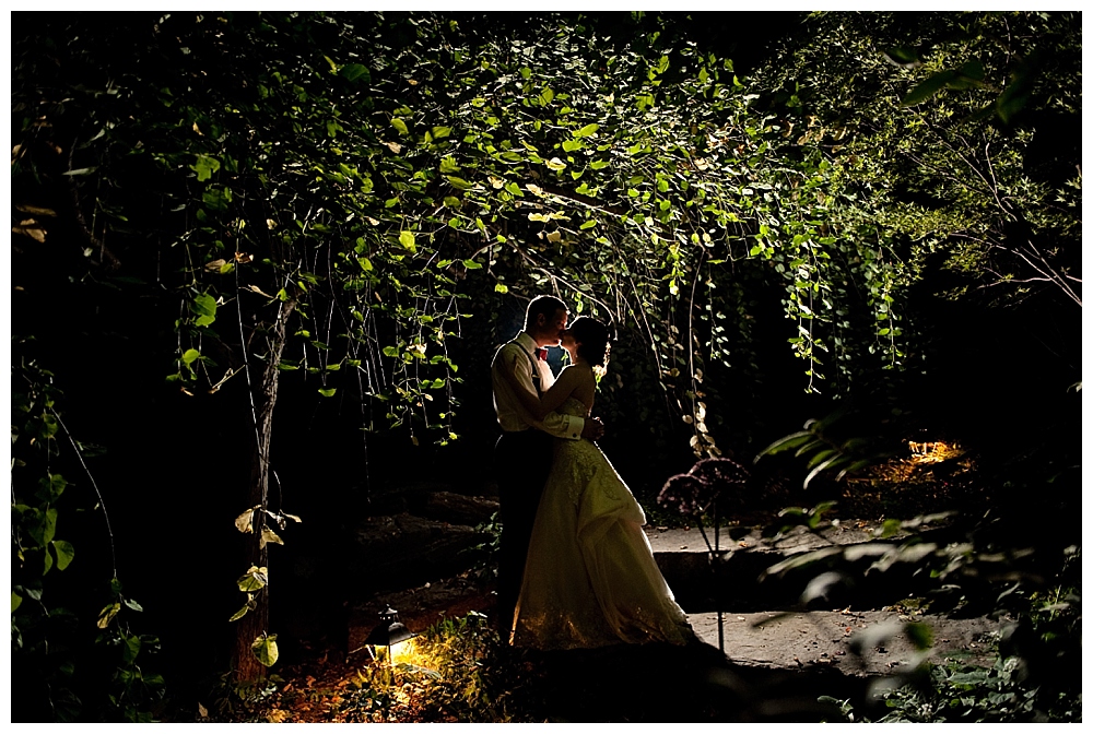 backlit silhouette night image of bride and groom