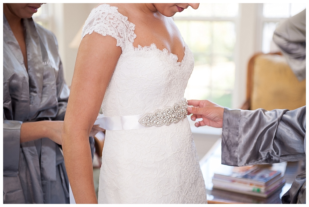 Bride putting on dress