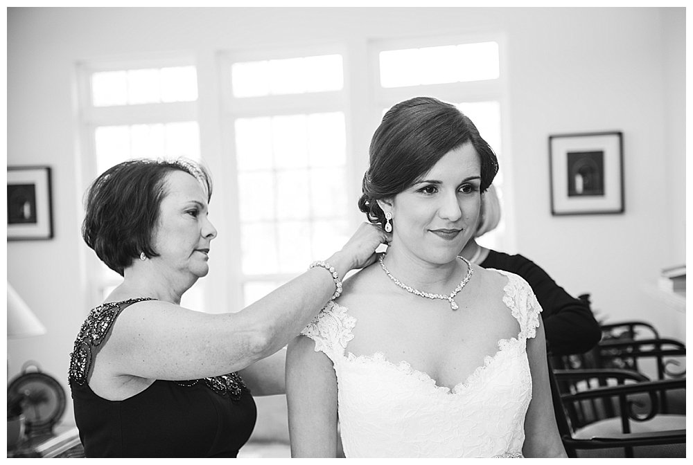 Bride putting on dress