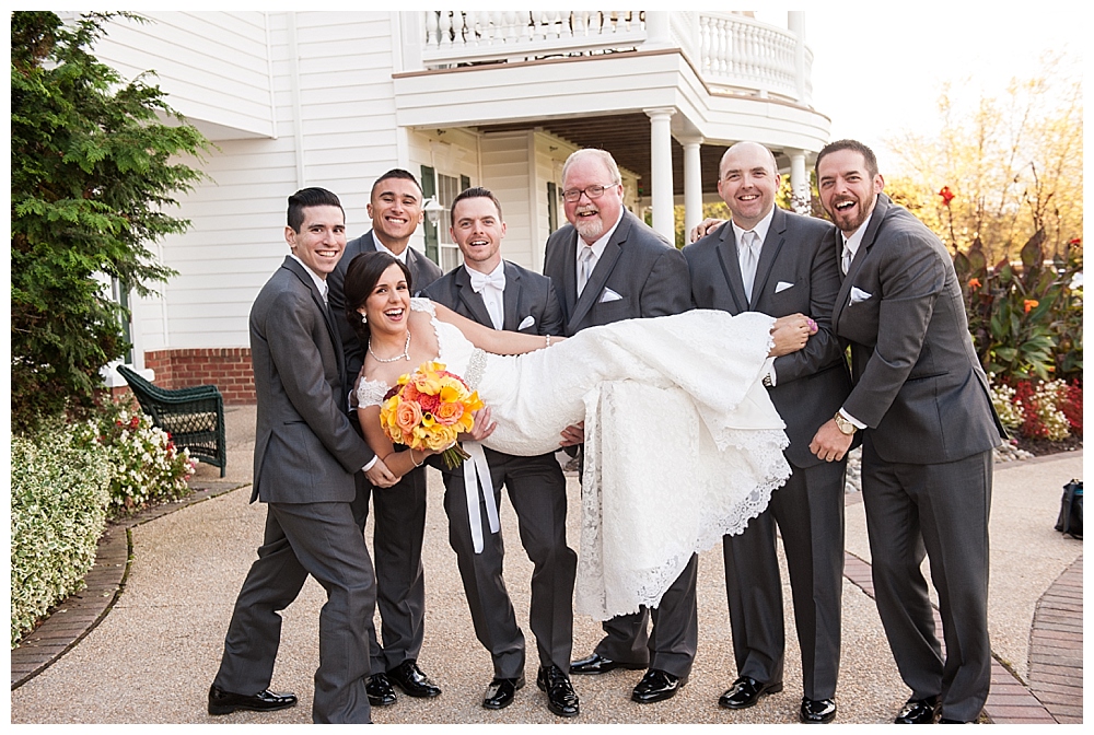 groomsmen picking up bride