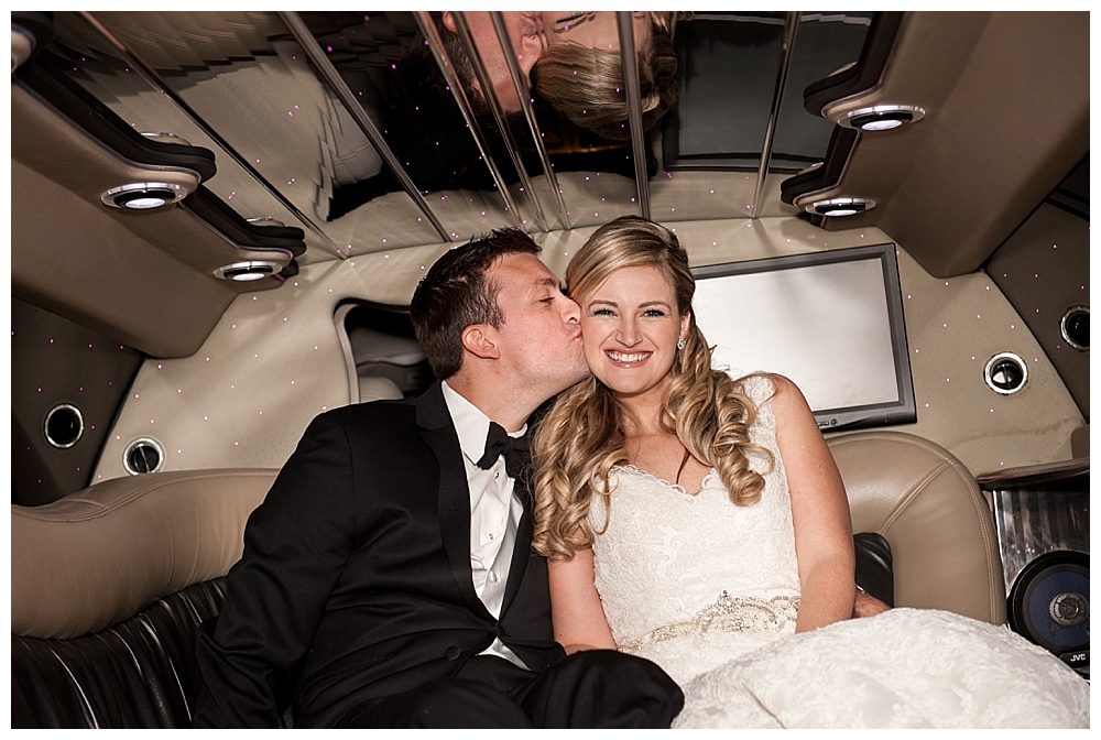 bride and groom in a limo