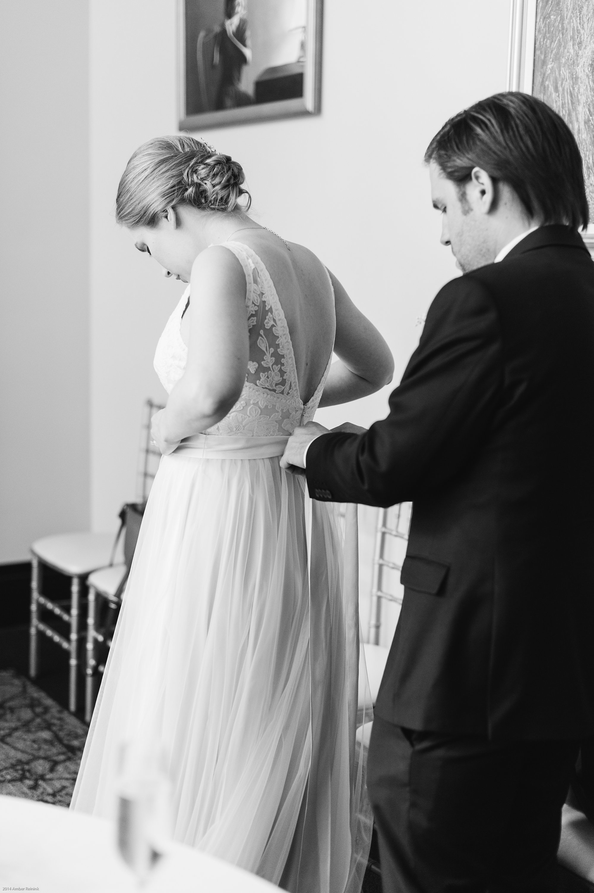 groom helping bride tie bow on wedding gown before ceremony 2941 restaurant wedding Vienna Virginia