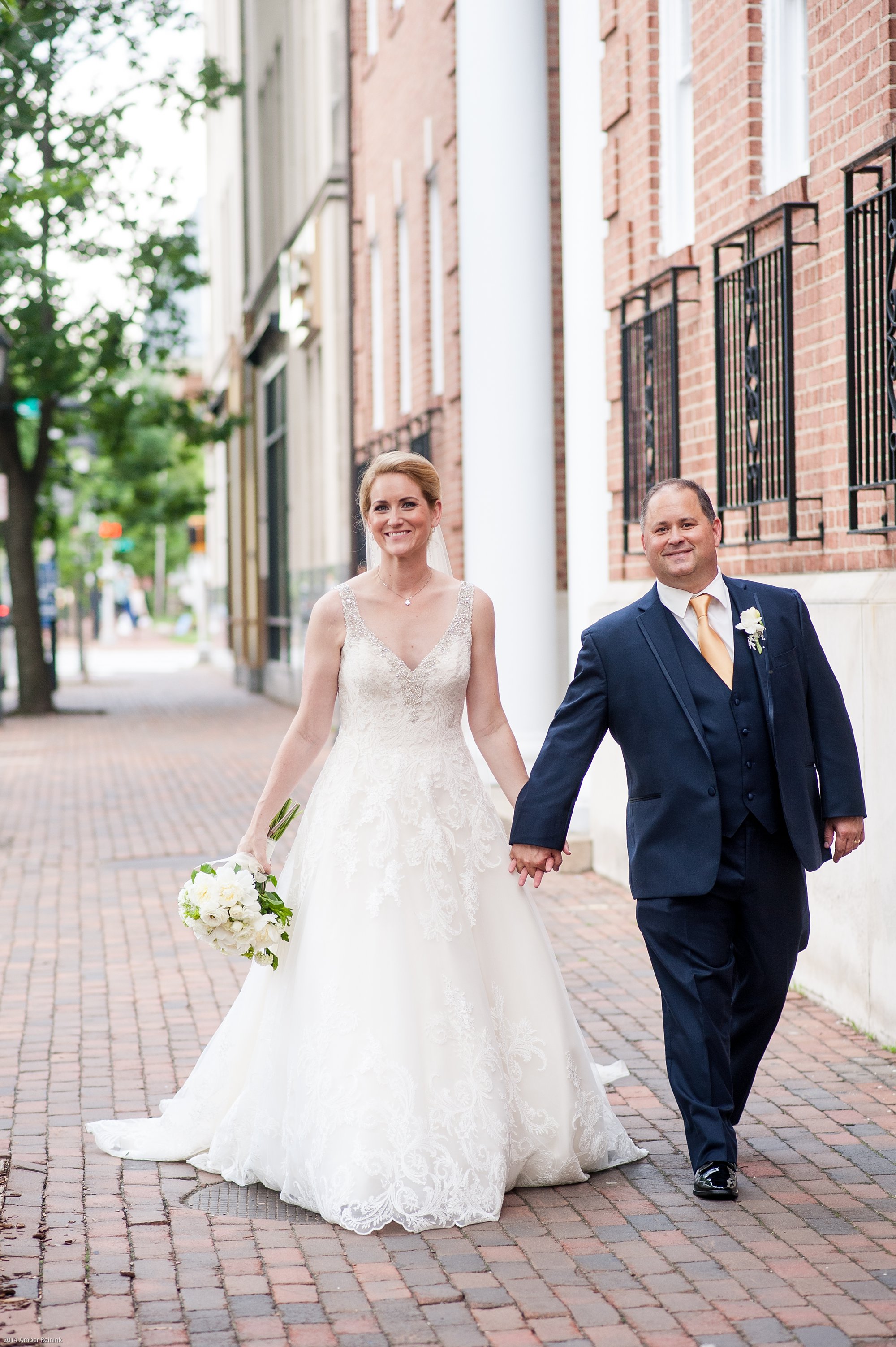 Old town Alexandria wedding pictures walking on sidewalk outside of Washington street united methodist church