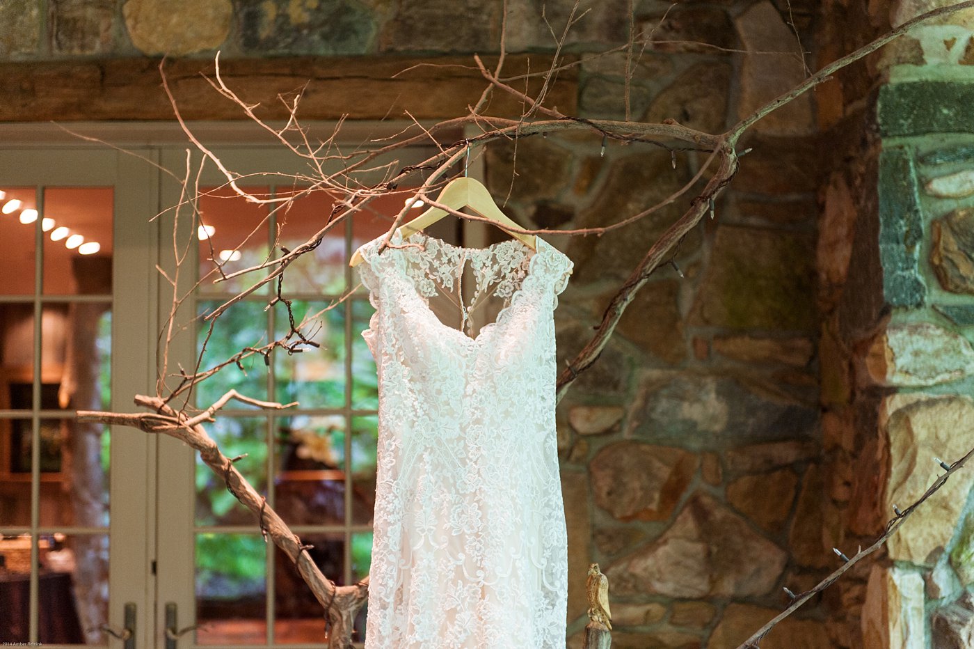 Wedding dress hanging from wooden bench at Thorpewood Mountain Memories wedding Thurmont, MD