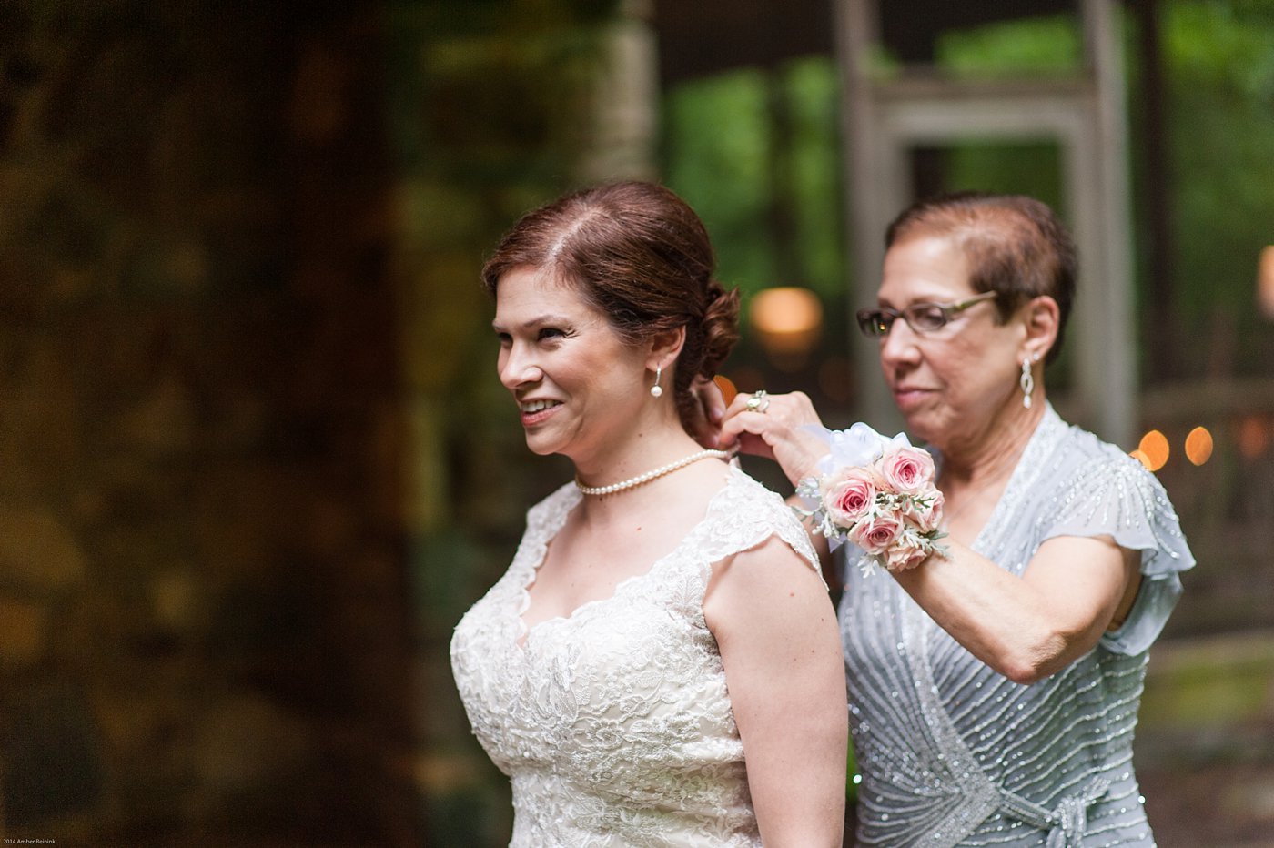 Bride getting ready with mother putting on her pearls at Thorpewood Mountain Memories Wedding Thurmont, MD